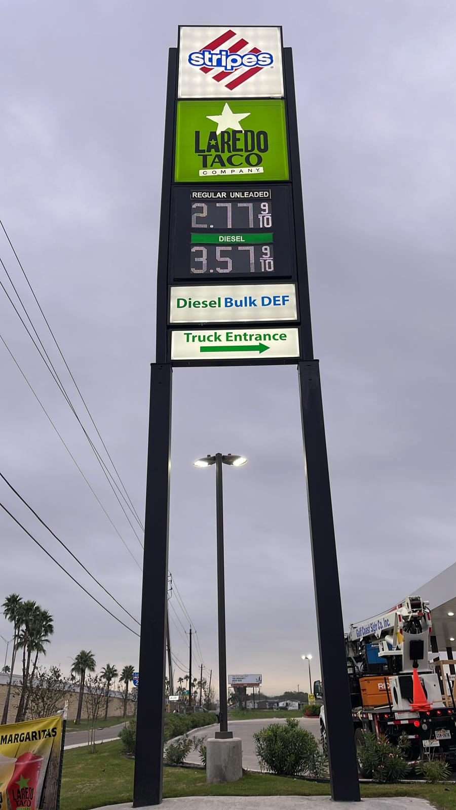 Synchronized branding for Stripes and Laredo Taco Company with a custom-designed pylon sign featuring fuel prices and amenities.